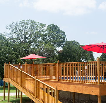 Peaceful RV sites surrounded by trees at Queen & Duke RV Resort in Whitesboro, Texas